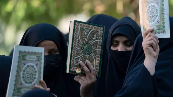 quran Women holding Qurans in their hands are demonstrating against the burning of Qurans in Sweden and Denmark