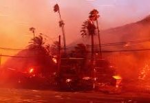 Aerial assault aims to stem LA Palisades fire eastward spread